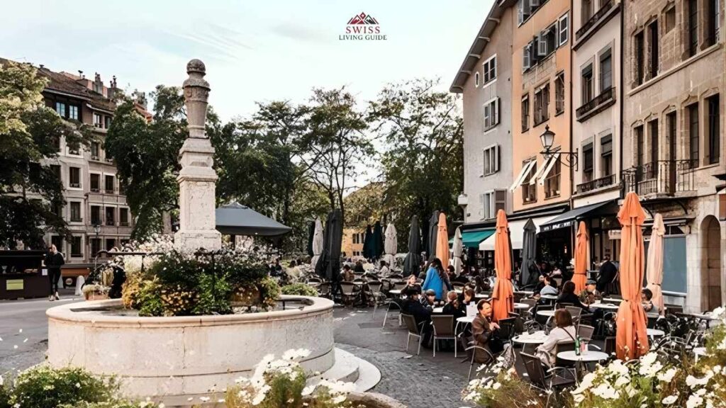 Charming cobblestone street in Geneva Old Town with colorful window flowers and historic buildings
