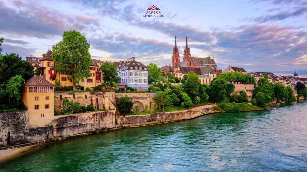 Basel skyline at golden hour with the Rhine River and Basel Minster glowing in warm sunset light