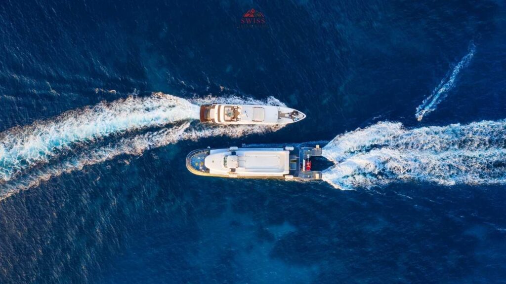 Boat cruising on Lake Zurich with scenic views of the Alps under a clear summer sky.