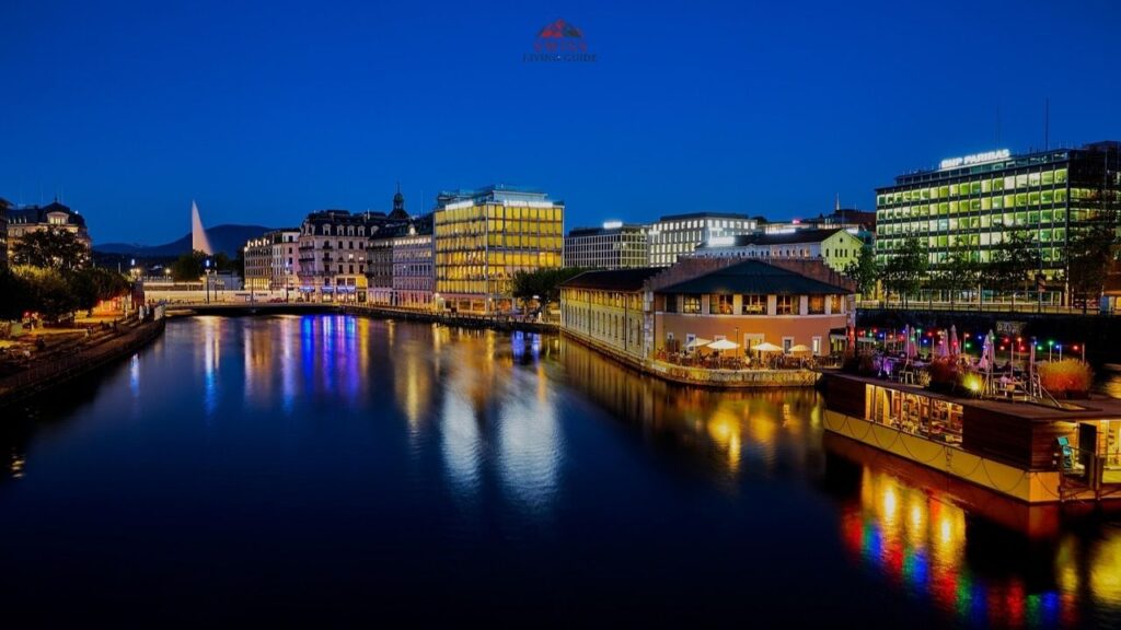 Geneva city center at night with glowing lights reflecting on Lake Geneva near Bel-Air Bridge