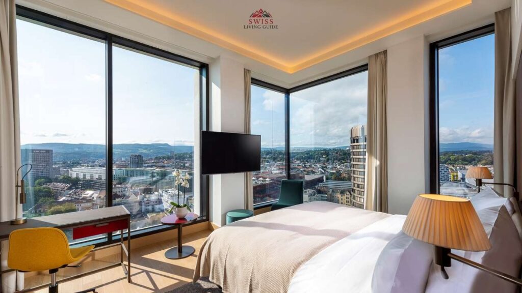 Modern hotel room in Basel city centre with cozy interior and rooftop view of the old town and Rhine River